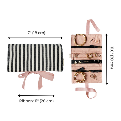 Bag-all Couture Jewelry Roll Medium Striped in black and white with pink lining, featuring multiple compartments for jewelry storage. Roll-up design with dimensions 7x11 inches and pink ribbon closure.