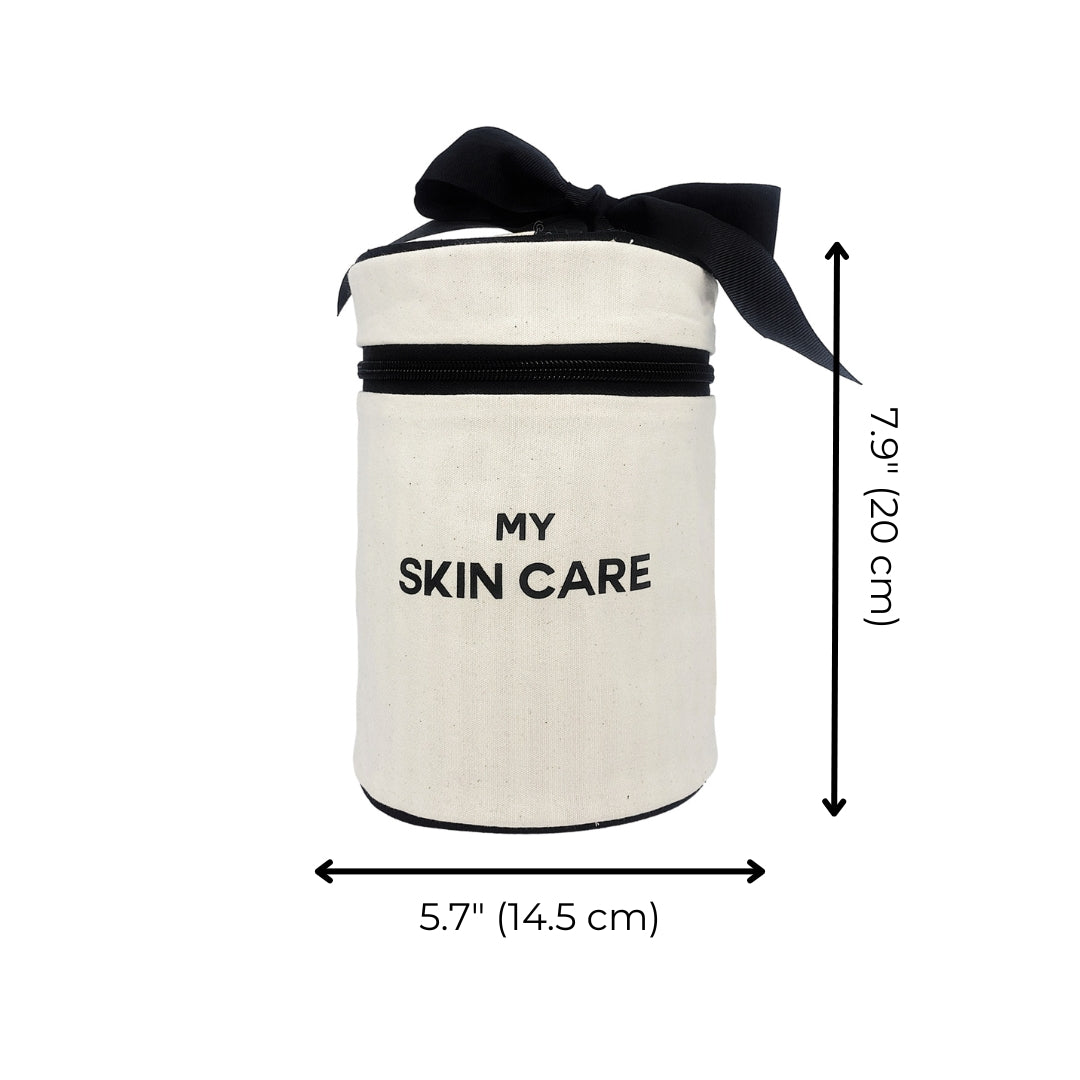 Bag-all Round Skin Care Case with Handle in cream canvas, featuring black bow, text 'MY SKIN CARE', zippered closure, waterproof lining, 7.9 inches tall by 5.7 inches wide