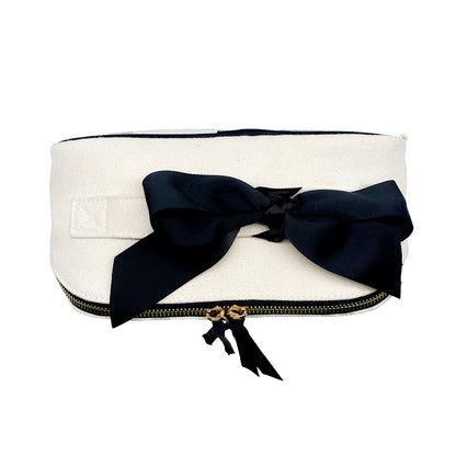 Bag-all Accordion Box Makeup & Toiletry in Cream, elegantly folded with a black ribbon. Compact, stylish, and perfect for travel organization