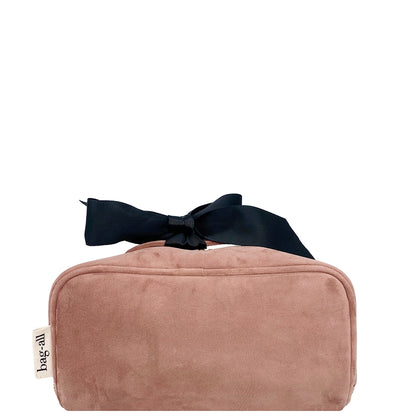 Bottom view of Bag-all Accordion Box Makeup & Toiletry in Pink Velvet. Features durable velvet fabric, contrast piping, and a chic bow detail