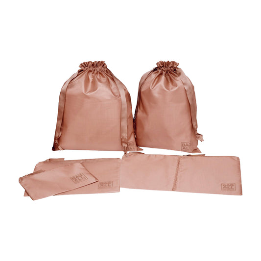 Bag-all Packing Bags Set in recycled nylon, 5-pack in pink/blush featuring drawstring closures and multi-sized organizer bags made from eco-friendly repurposed plastic bottles