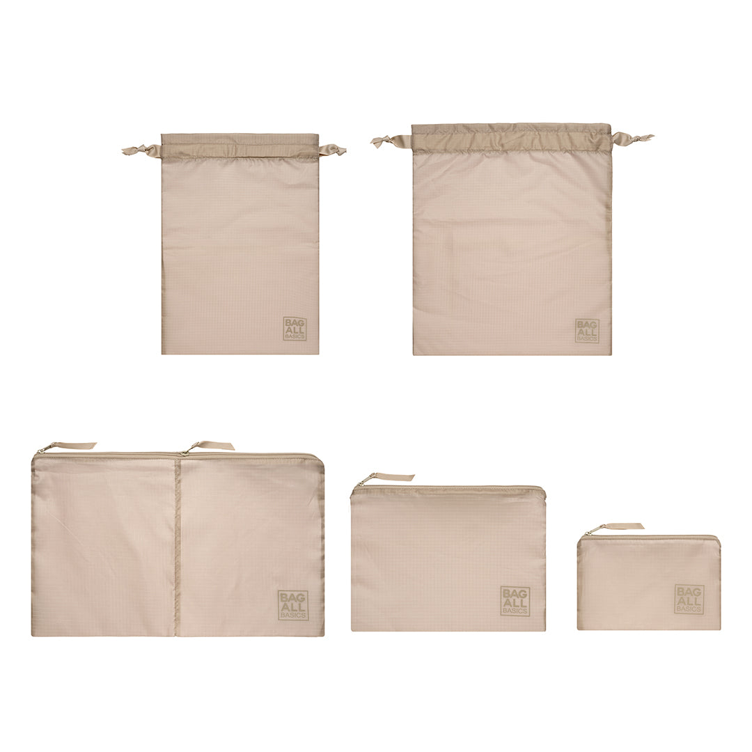 Bag-all Packing Bags Set in recycled nylon featuring 5 taupe organizer bags in varying sizes, from small toiletry pouches to large dual-compartment bags, all made from eco-friendly repurposed materials