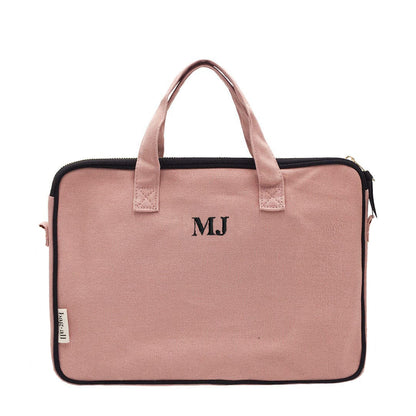 Bag-all pink laptop case with handles and charger pocket, featuring monogram initials, padded striped interior lining, fits 13-inch devices, perfect for business and travel