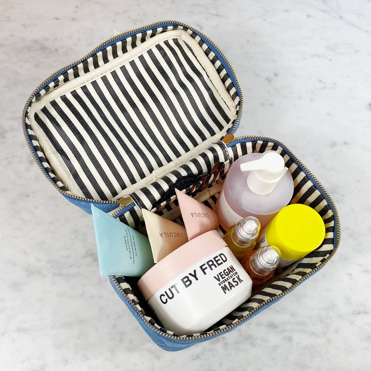 Bag-all My Makeup Cosmetic Box in Denim featuring striped interior lining, spacious compartments for beauty products, and waterproof design with zip closure