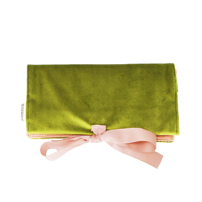 Bag-all Couture Jewelry Roll in luxurious green velvet with pink ribbon closure, featuring multiple compartments for organized jewelry storage and travel