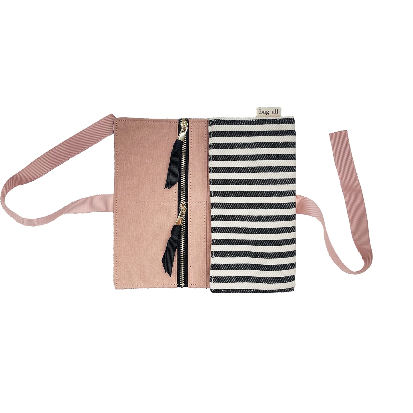 Bag-all Couture Jewelry Roll Medium featuring black and white stripes, pink lining, multiple zipper compartments and leather details, perfect for organizing jewelry while traveling