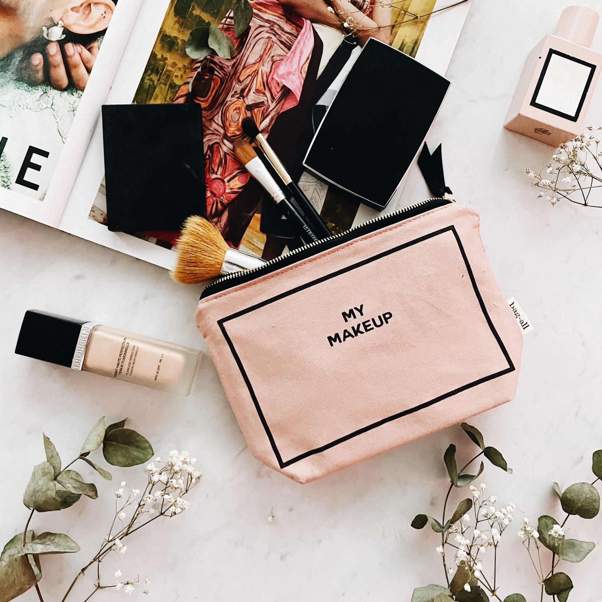 Bag-all Handbag Organizer Trio in pink/blush featuring cotton makeup pouch with "MY MAKEUP" text, displayed with makeup brush and beauty products against white surface with eucalyptus leaves