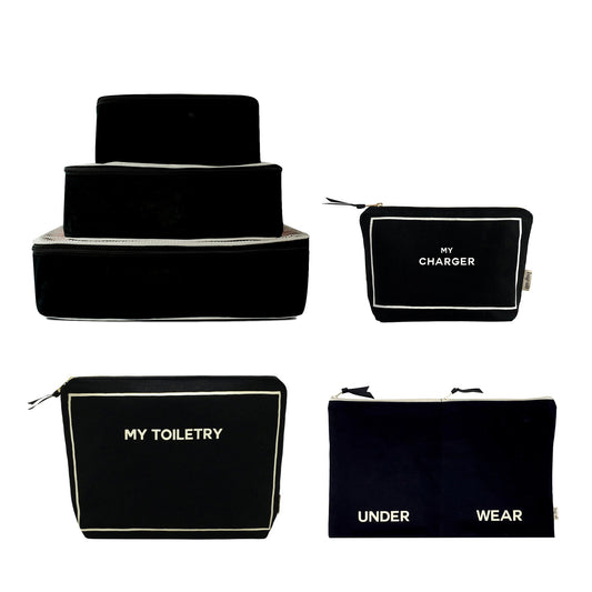 Bag-all Weekend Essential Packing Set in black featuring cotton packing cubes, toiletry pouch, charger case and underwear organizer with white trim and text labeling