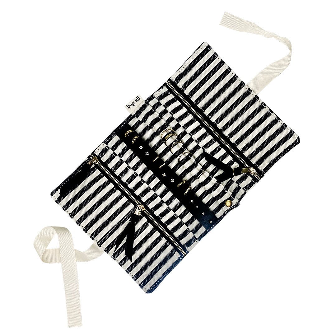 Bag-all Jewelry Organizer Travel Pouch in classic black and white stripes, featuring three zippered compartments, leather earring holder, and padded ring storage with elegant ribbon ties