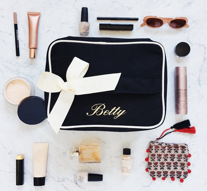 Bag-all My Vanity Large Beauty Box in black with white trim and ribbon, surrounded by makeup essentials, cosmetics, and accessories on marble background, perfect for organizing beauty products