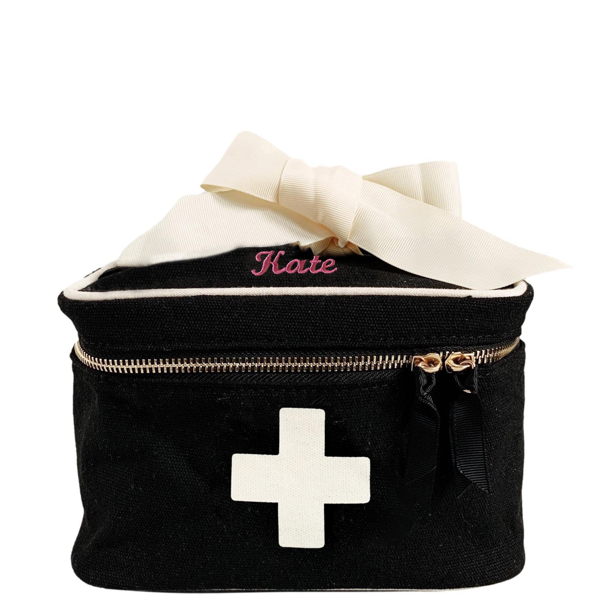 Bag-all Meds and First Aid Storage Box in Black with white medical cross, cream ribbon handle, dual metal zippers, and personalized name embroidery - stylish medical storage solution