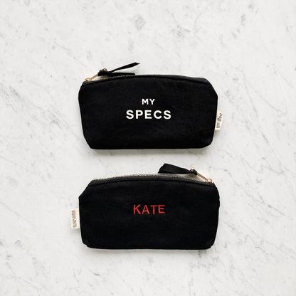 "KATE" monogrammed on bag in classic font