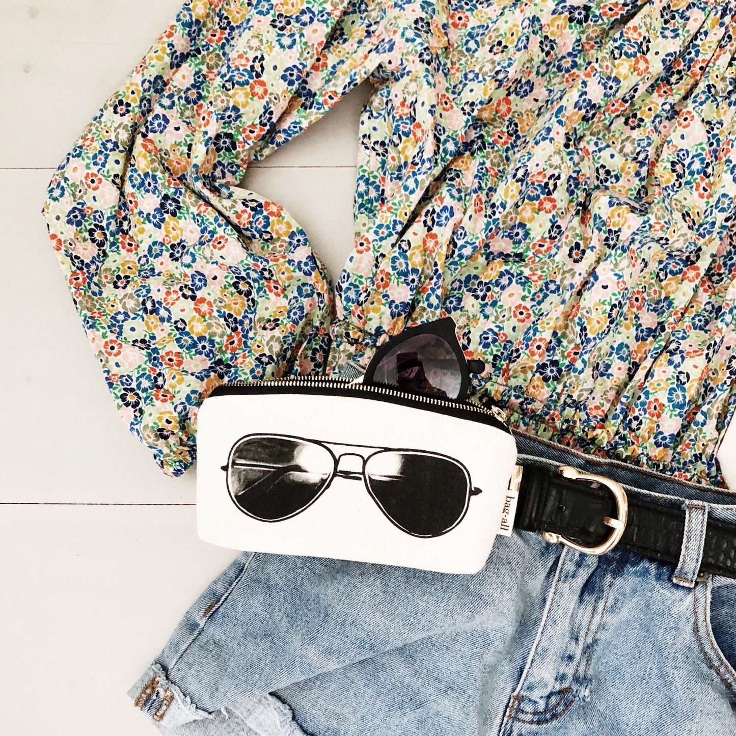 Pilot glasses padded sunglasses case with a floral shirt. 