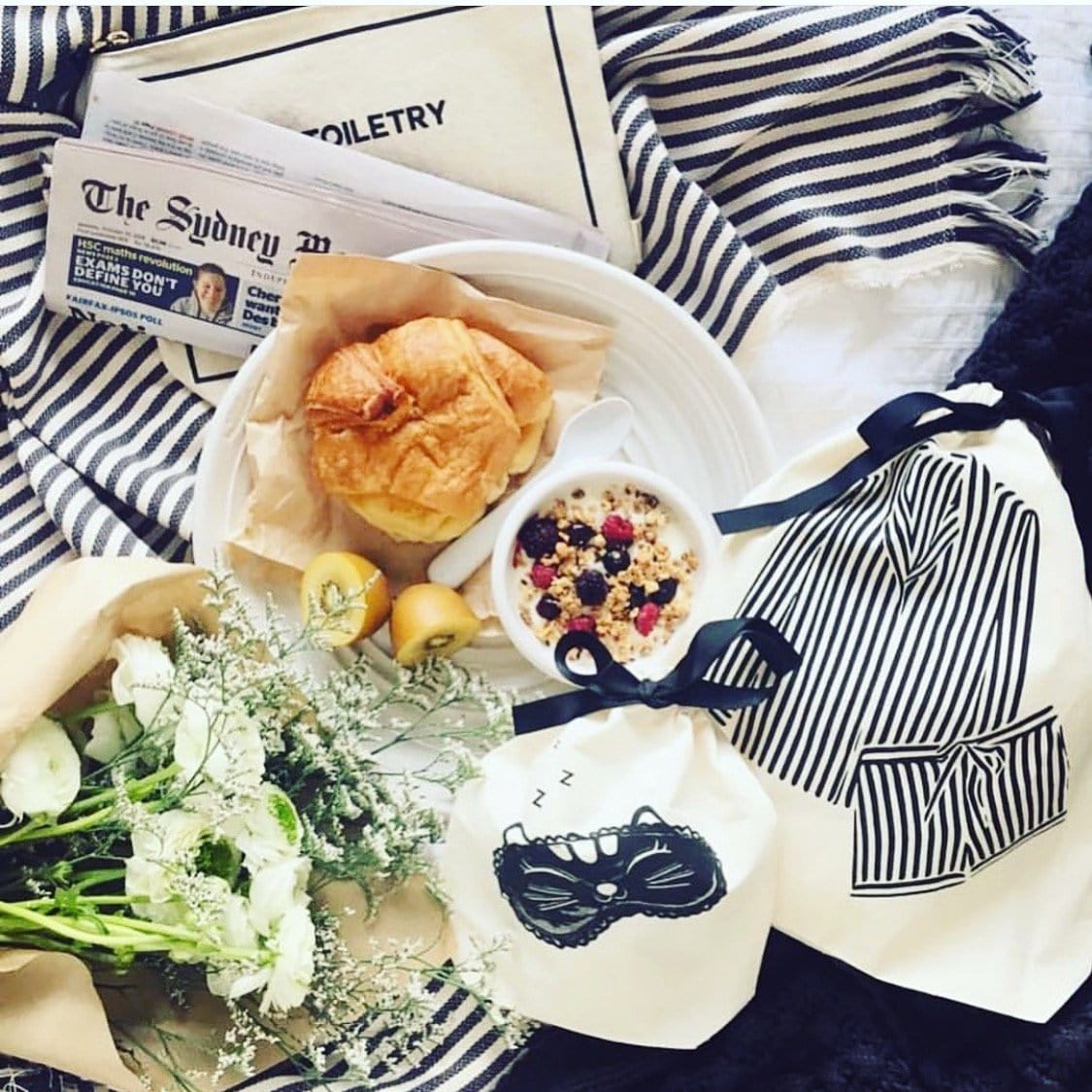 Coffee and breakfast next to a striped coffee bag. 